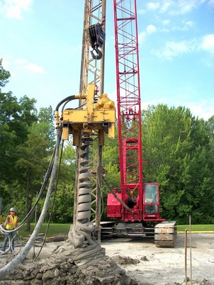 Drilling an auger cast pile
